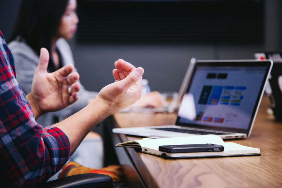 Hands gesturing in meeting setting