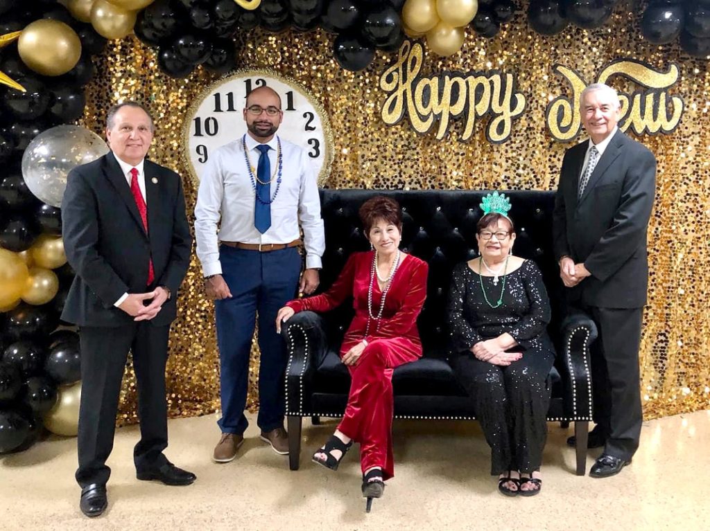 Formal gathering with decorated backdrop